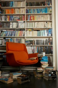 comfortable chair surrounded by books